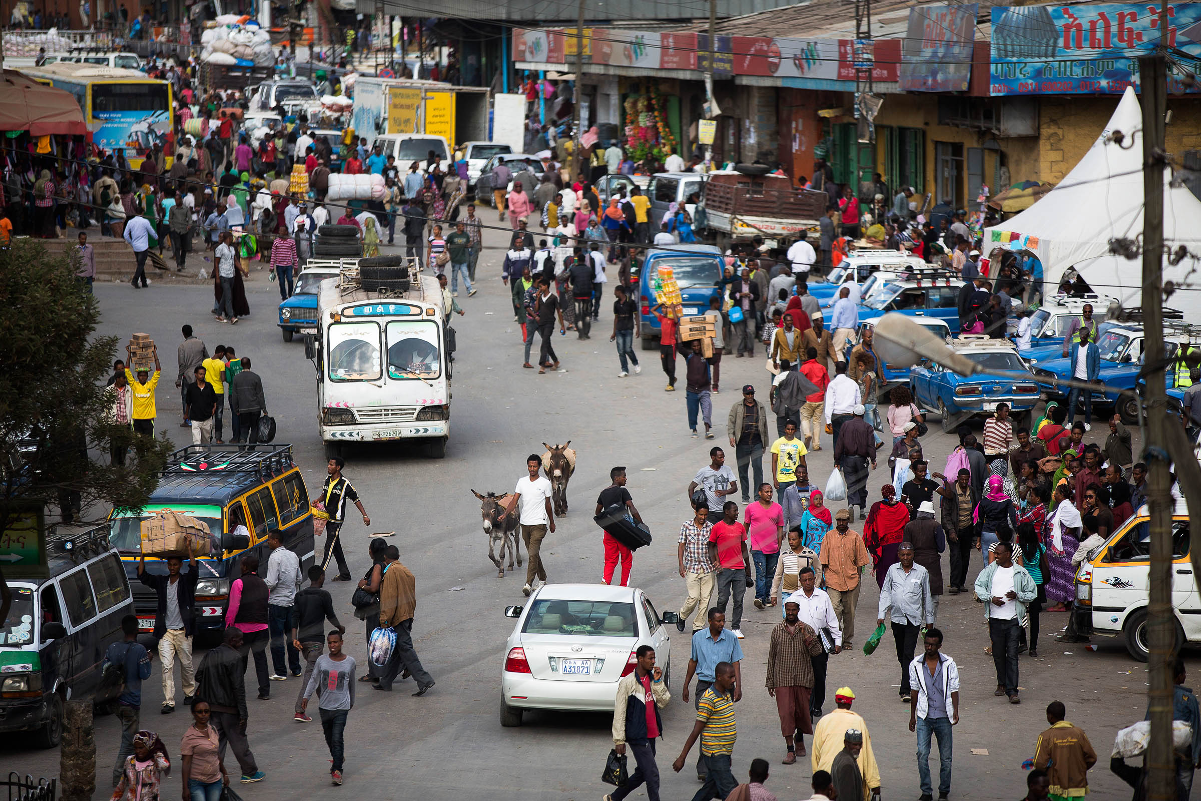 Many roads, like this one in Addis Ababa, have no sidewalks or street lights, and pedestrians are often forced to walk alongside motorized vehicles.